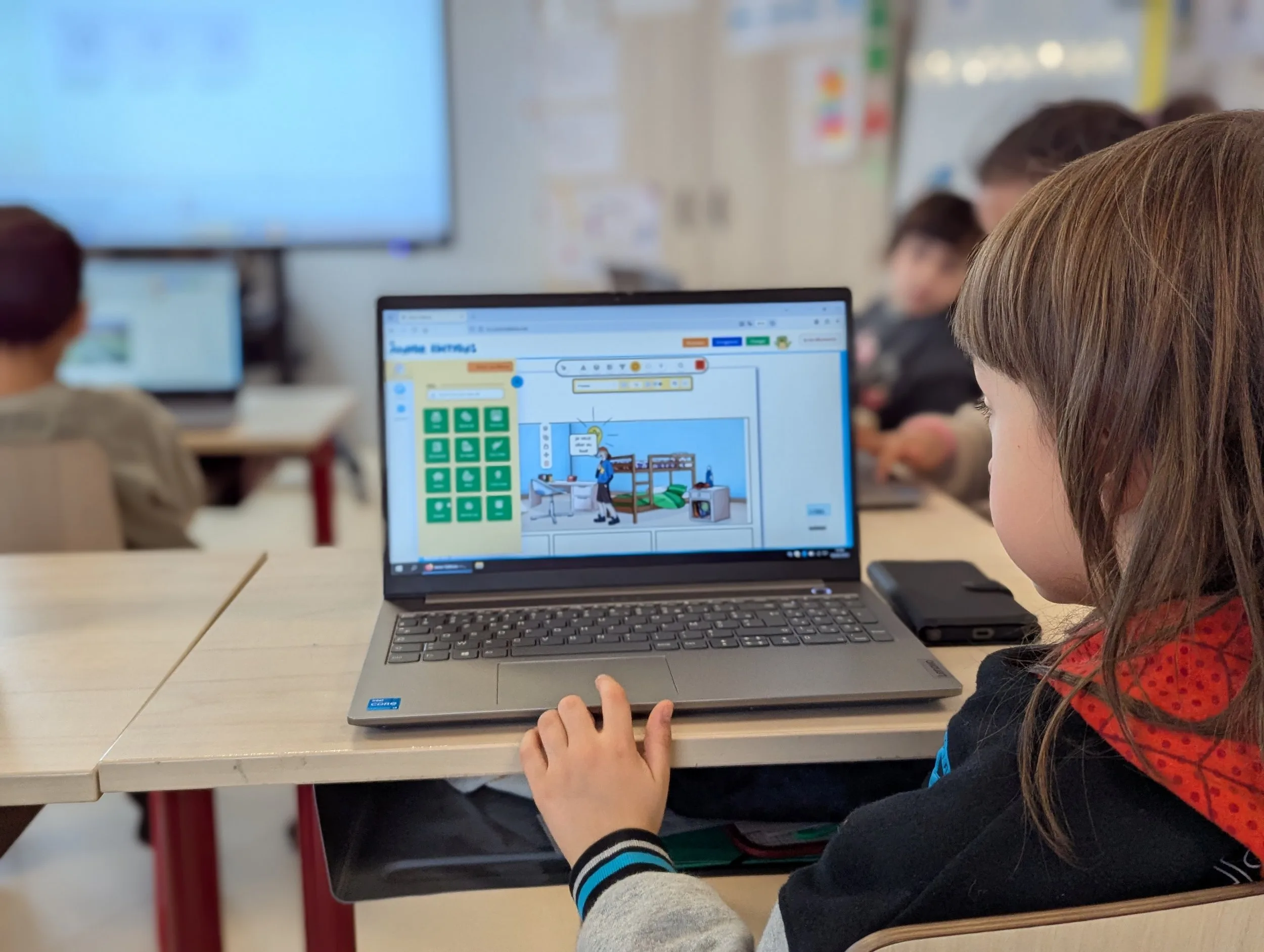 A group of children sitting at desks in a classroom using laptops, the scene shows an educational, digital atmosphere.